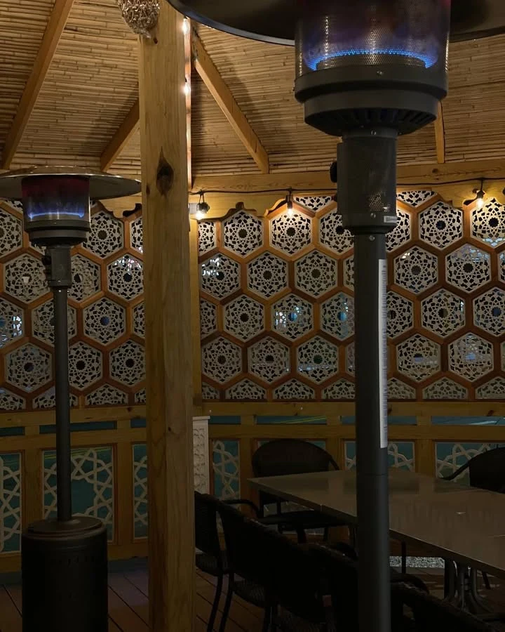 The dining room at Oasis, with its patterned wood screens